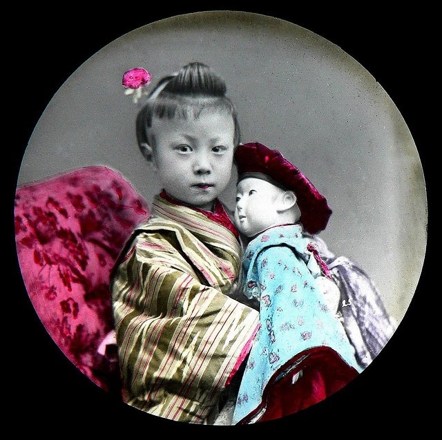 Young Japanese girl and her doll. Late 1870s to 1880s 